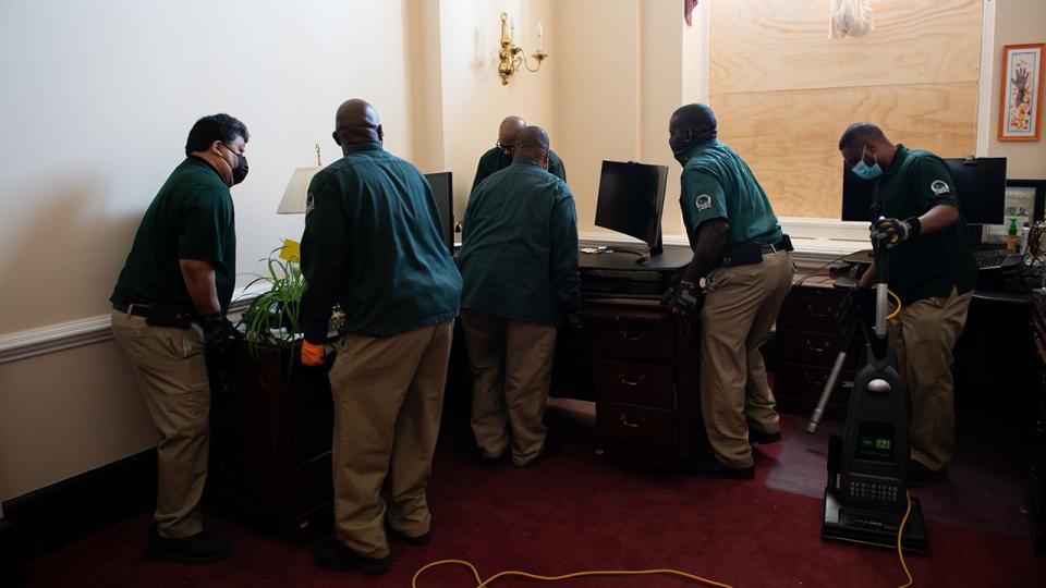 Workers clean an office at the U.S. Capitol building in Washington, D.C., U.S., on Thursday, Jan. 7, 2021. Joe Biden was formally recognized by Congress as the next U.S. president early Thursday, ending two months of failed challenges by his predecessor, Donald Trump, that exploded into violence at the U.S. Capitol as lawmakers met to ratify the election result.