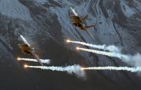 FILE PHOTO: Swiss Air Force F/A18 Hornet fighter jets release flares over the Axalp