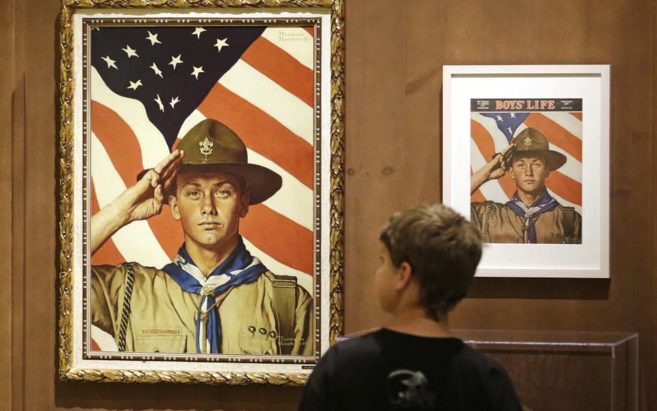 A boy looks over a Boy Scout-themed Norman Rockwell exhibition at the Church History Museum in Salt Lake City, Utah - AP