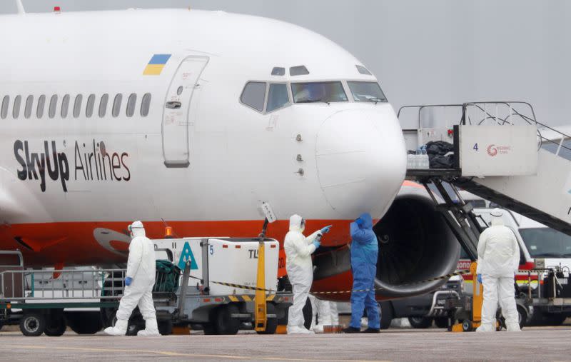 An aircraft transporting passengers from China is seen at an airport outside Kiev