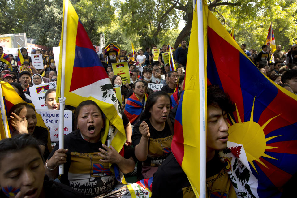 Exile Tibetans shout slogans to mark the 60th anniversary of the March 10, 1959 Tibetan Uprising Day, in New Delhi, India, Sunday, March 10, 2019. The uprising of the Tibetan people against the Chinese rule was brutally quelled by Chinese army forcing the spiritual leader the Dalai Lama and thousands of Tibetans to come into exile. Every year exile Tibetans mark this day as the National Uprising Day. (AP Photo/Manish Swarup)