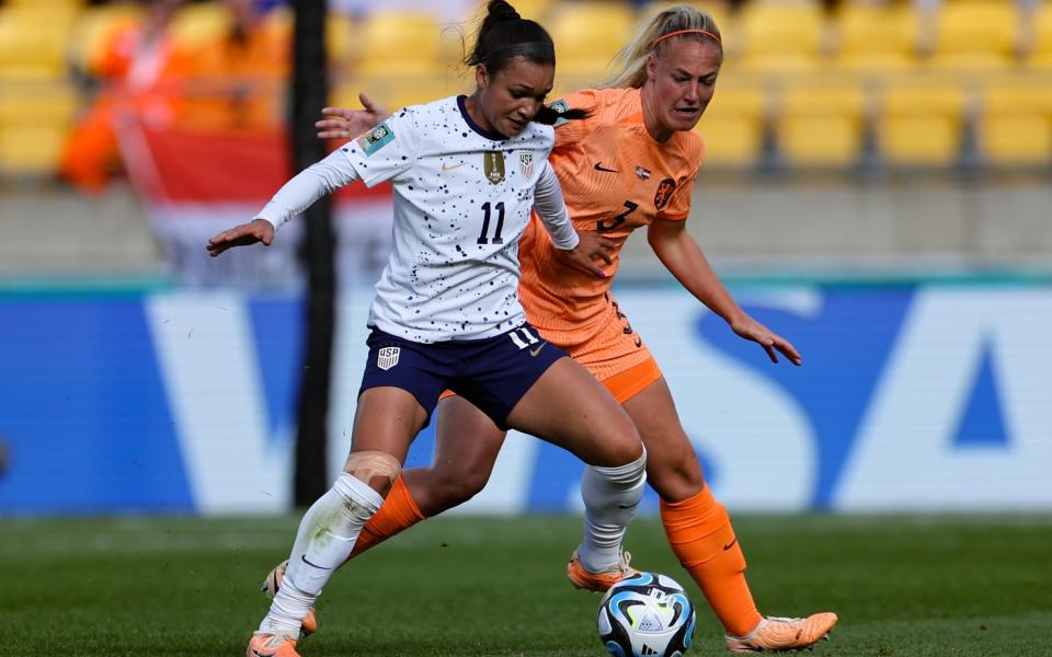 Sophia Smith of USA, left, and Stefanie van der Gragt of Netherlands compete for the ball - US women&#39;s team refuse to sing national anthem before World Cup draw with Netherlands