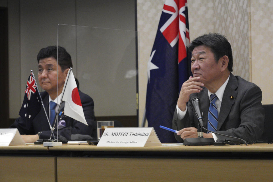 Japanese Foreign Minister Toshimitsu Motegi, right, and Defense Minister Nobuo Kishi, left, attend a video conference with Australian Foreign Minister Marise Payne and Australian Defense Minister Peter Dutton at Foreign Ministry in Tokyo during their two-plus-two ministerial meeting Wednesday, June 9, 2021, in Tokyo. (AP Photo/Eugene Hoshiko, Pool)