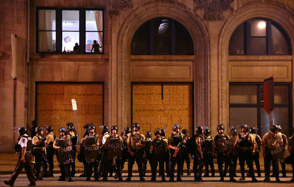 Residents watch as St. Louis County Police officers stand along Tucker Boulevard in downtown St. Louis as police order protesters to clear the area on Sunday, Sept. 17.<i></i> (Photo: Photo by Robert Cohen/St. Louis Post-Dispatch)