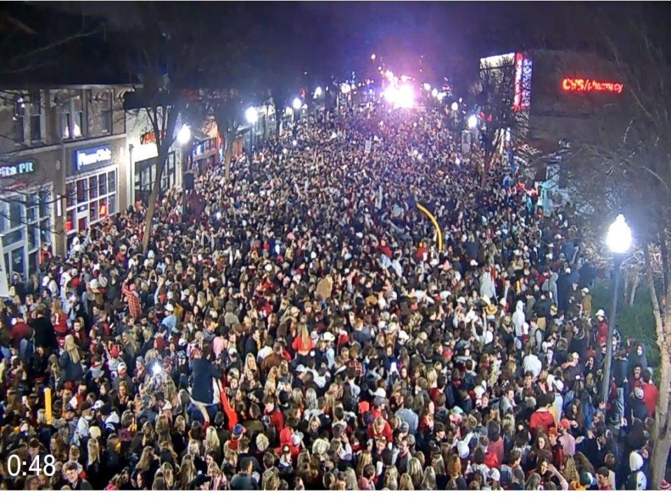 Fans rush onto University Boulevard in Tuscaloosa, Ala., after the University of Alabama won the College Football Playoff on Jan. 11.