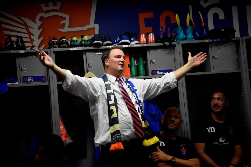 FC Cincinnati Co-CEO Jeff Berding after the first Hell is Real derby in 2017. Here he is wearing a scarf with the rivalry name on both sides, one side orange and blue for FC Cincinnati and the other side black and gold for Columbus Crew.