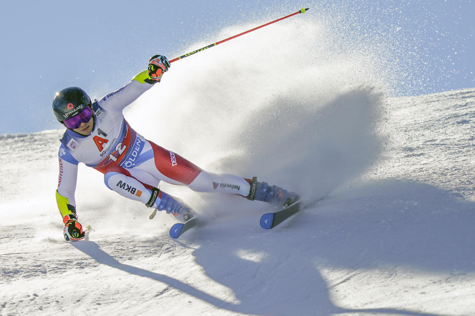 Switzerland's Gino Caviezel speeds down the course during an alpine ski, men's World Cup giant slalom in Soelden, Austria, Sunday, Oct. 18, 2020. (AP Photo/Giovanni Auletta)