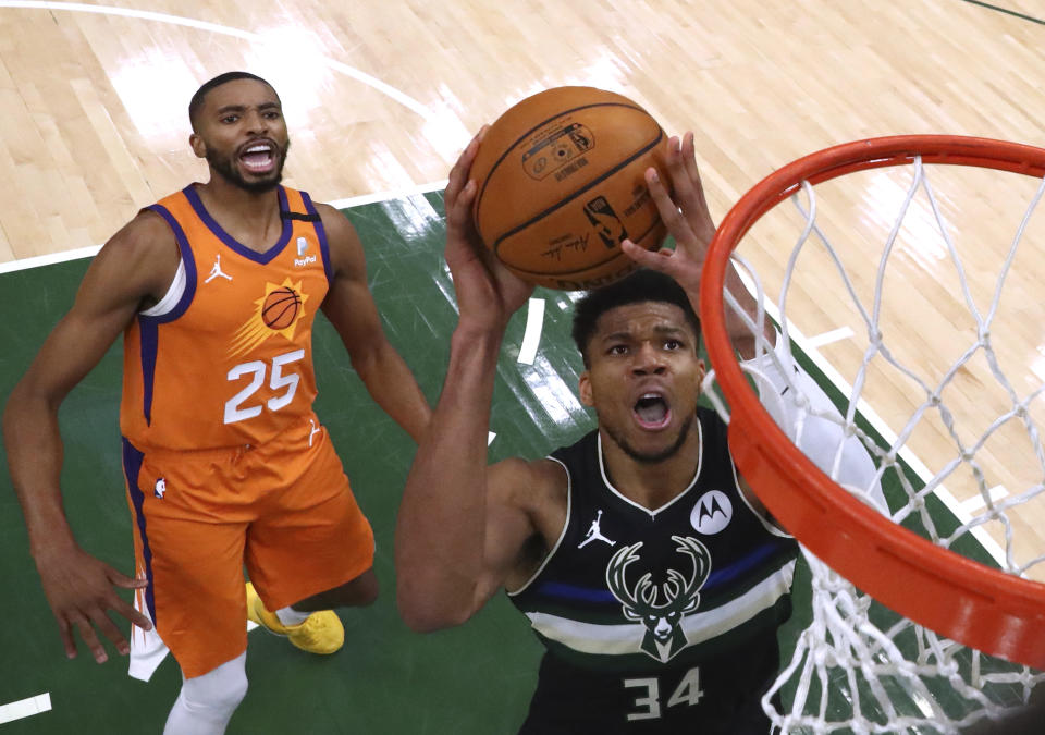 Milwaukee Bucks forward Giannis Antetokounmpo (34) shoots past Phoenix Suns forward Mikal Bridges (25) during Game 6 of basketball's NBA Finals, Tuesday, July 20, 2021, in Milwaukee. (Mark J. Rebilas/Pool Photo via AP)