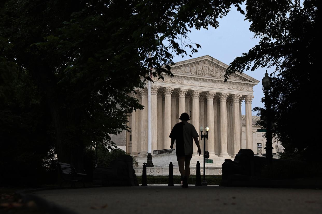 FILE: A pedestrian is seen close to the U.S. Supreme Court on June 5, 2023. The highest court in the land decided June 8 that the Alabama congressional districts unlawfully dilute the Black vote in violation of the Voting Rights Act of 1965.