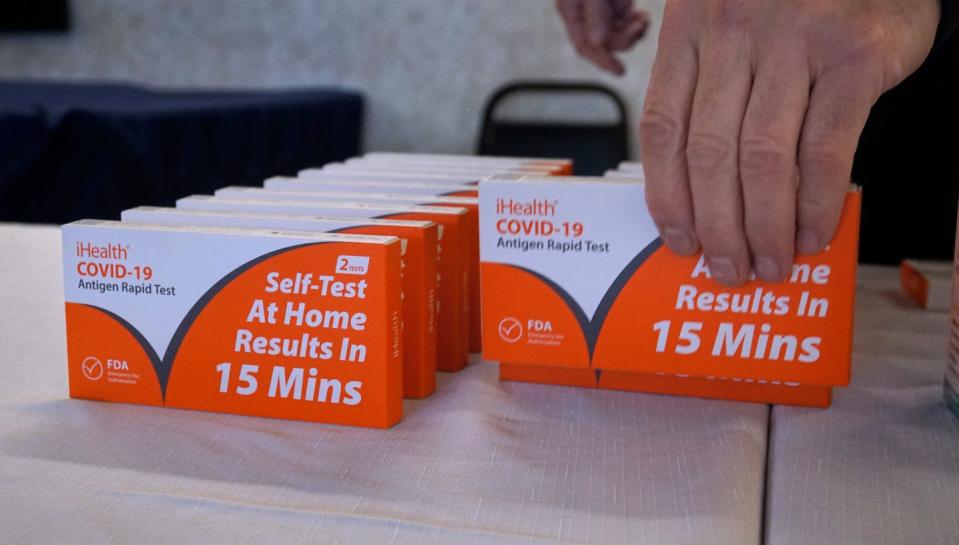 Chief Glenn J. Quick of the East Providence Fire Department sets out home COVID test kits for residents to take before Thursday's news conference at Parkway Towers in East Providence.