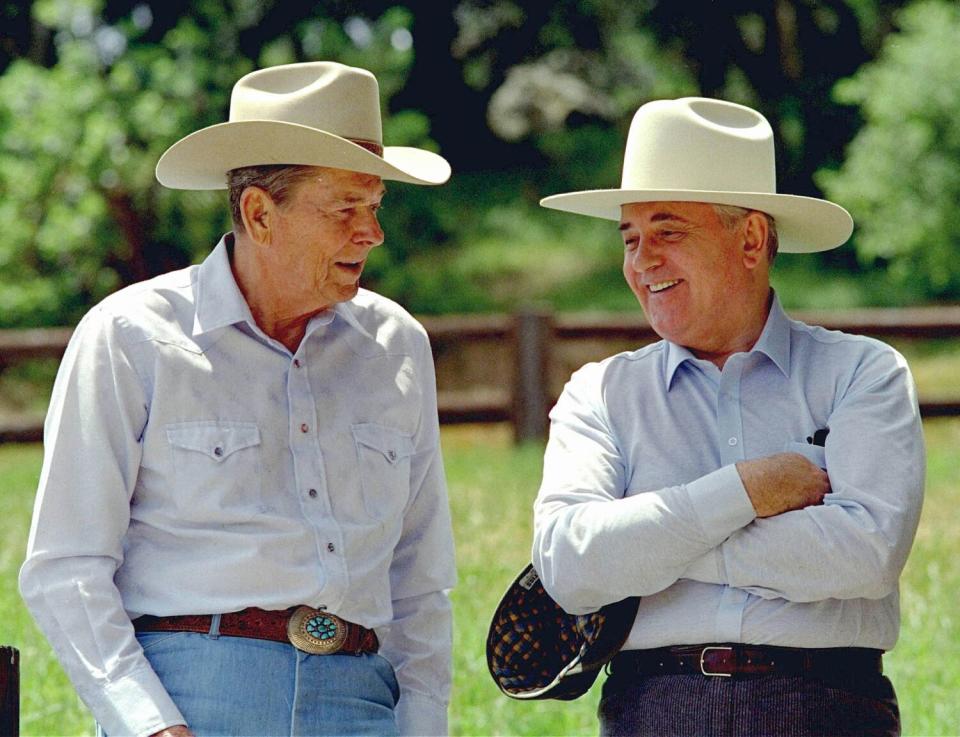 Former President Ronald Reagan, left, and former Soviet President Mikhail Gorbachev don cowboy hats