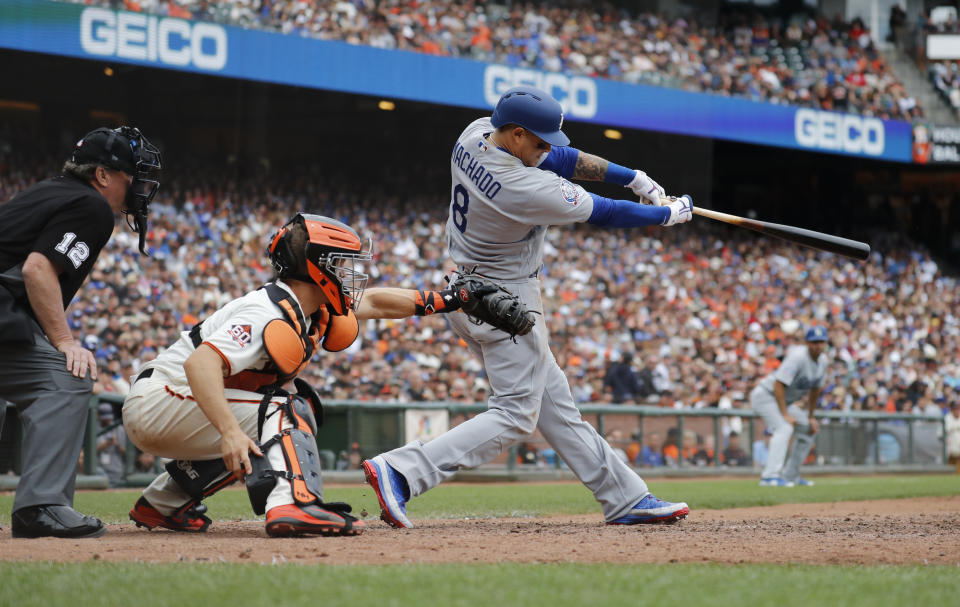 Los Angeles Dodgers' Manny Machado (8) hits a RBI triple for the go ahead run against the San Francisco Giants during the eighth inning of a baseball game in San Francisco, Saturday, Sept. 29, 2018. (AP Photo/Jim Gensheimer)