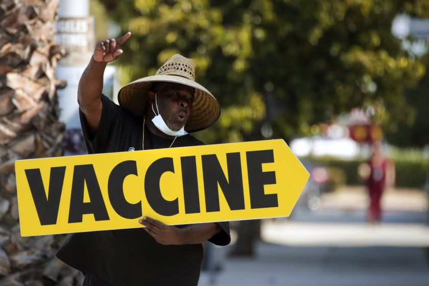 Los Angeles, CA - July 16: Willie Golden directs people towards a mobile COVID-19 vaccine clinic, hosted by Mothers In Action in collaboration with L.A. County Department of Public Health at Mothers in Action on Friday, July 16, 2021 in Los Angeles, CA. (Irfan Khan / Los Angeles Times)