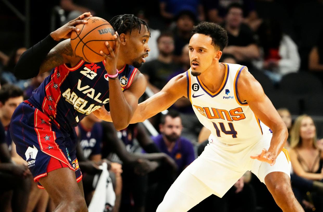 Phoenix Suns guard Landry Shamet (14) pressures Adelaide 36ers guard Antonius Cleveland (1) at Footprint Center in Phoenix on Oct. 2, 2022.