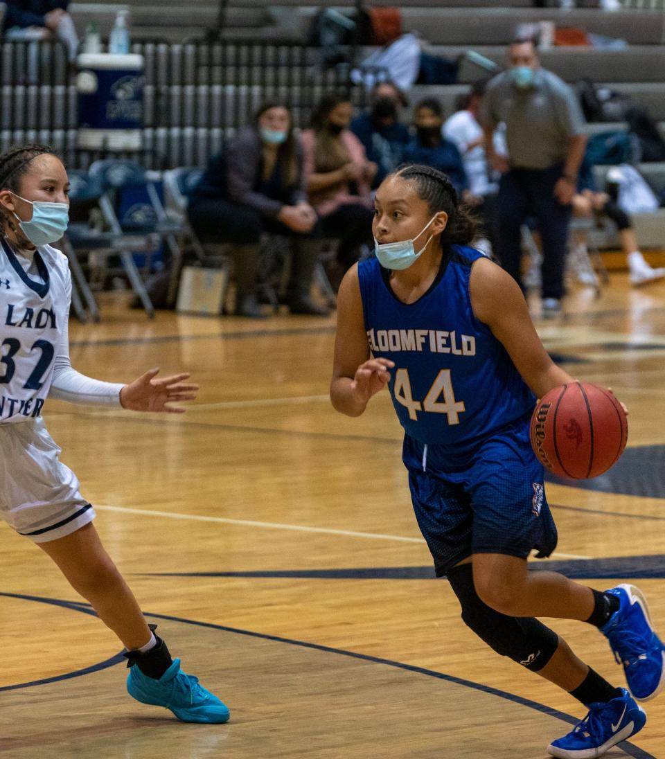 Bloomfield High School's (44) Danielle Johnson looks to make a run for the basket against Piedra Vista's Lanae Billy during their game Tuesday, Jan. 11, 2022 at Piedra Vista High School.