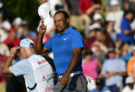 Tiger Woods finishes the 18th hole maintaining the lead at 12 under par during the third round of the Tour Championship golf tournament Saturday, Sept. 22, 2018, in Atlanta. (AP Photo/John Amis)