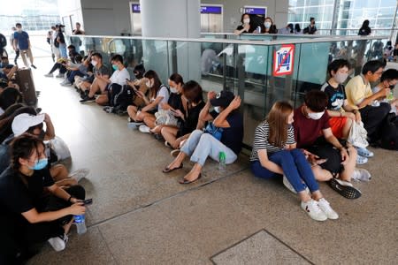 Anti-extradition bill protesters take rest outside the terminals at Hong Kong International Airport, in Hong Kong