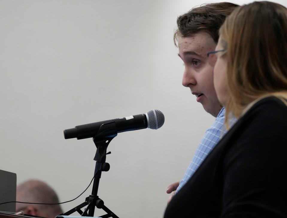 Tyler Pudleiner, who was struck and injured by Brooks' SUV, reads a victim statement as his mother, Katti Pudleiner, stands by his side during Darrell Brooks' sentencing hearing Tuesday in Waukesha.