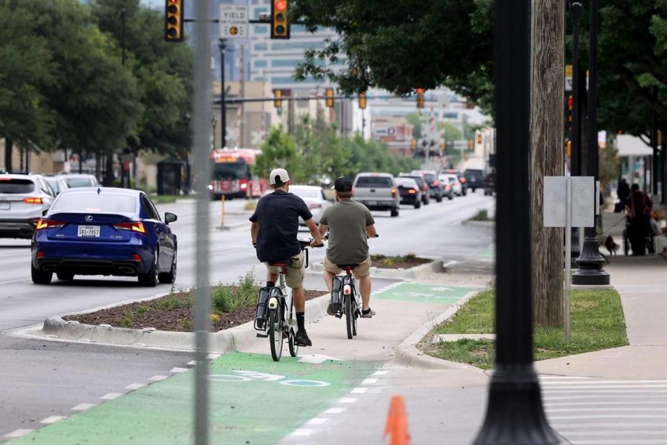 Cyclists ride on the protected bike lane on West 7th Street in Fort Worth on Tuesday, April 18, 2023. Fort Worth taxpayers spent $8.5 million for road improvements on a stretch of West 7th Street between University Drive and the Trinity River.