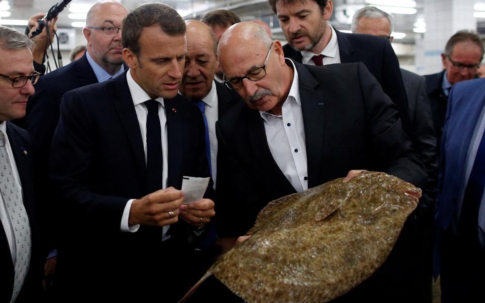 Emmanuel Macron visiting a fish market  - REUTERS