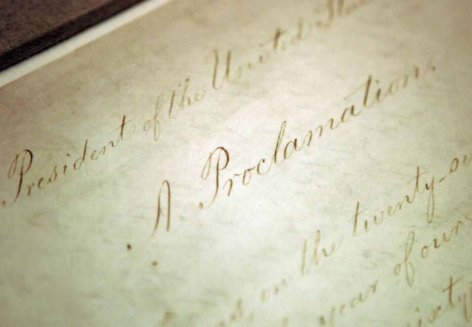 FILE - This Feb. 18, 2005, file photo shows the original Emancipation Proclamation on display in the Rotunda of the National Archives in Washington. President Abraham Lincoln first issued the Emancipation Proclamation declaring all slaves free in Confederate territory on Sept. 22, 1862. Juneteenth, the oldest holiday that commemorates the ending of slavery in the United States, originated 155 years ago. Celebrations have typically included parades, barbecues, concerts and readings of the Emancipation Proclamation. (AP Photo/Evan Vucci, File)