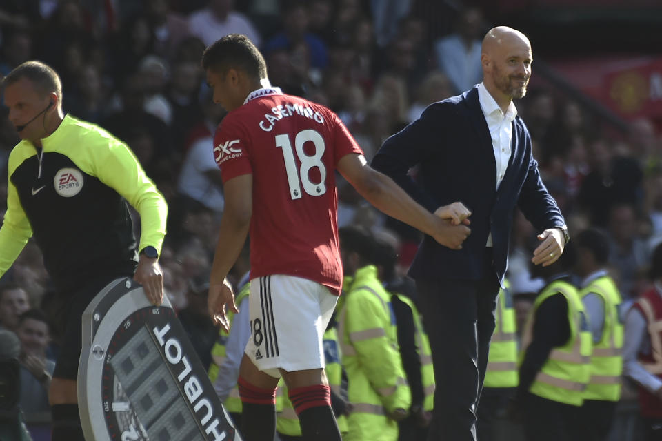 Manchester United's head coach Erik ten Hag, right, greets Manchester United's Casemiro as he leaves the pitch for substitution during the English Premier League soccer match between Manchester United and Fulham at Old Trafford in Manchester, England, Sunday, May 28, 2023. (AP Photo/Rui Vieira)