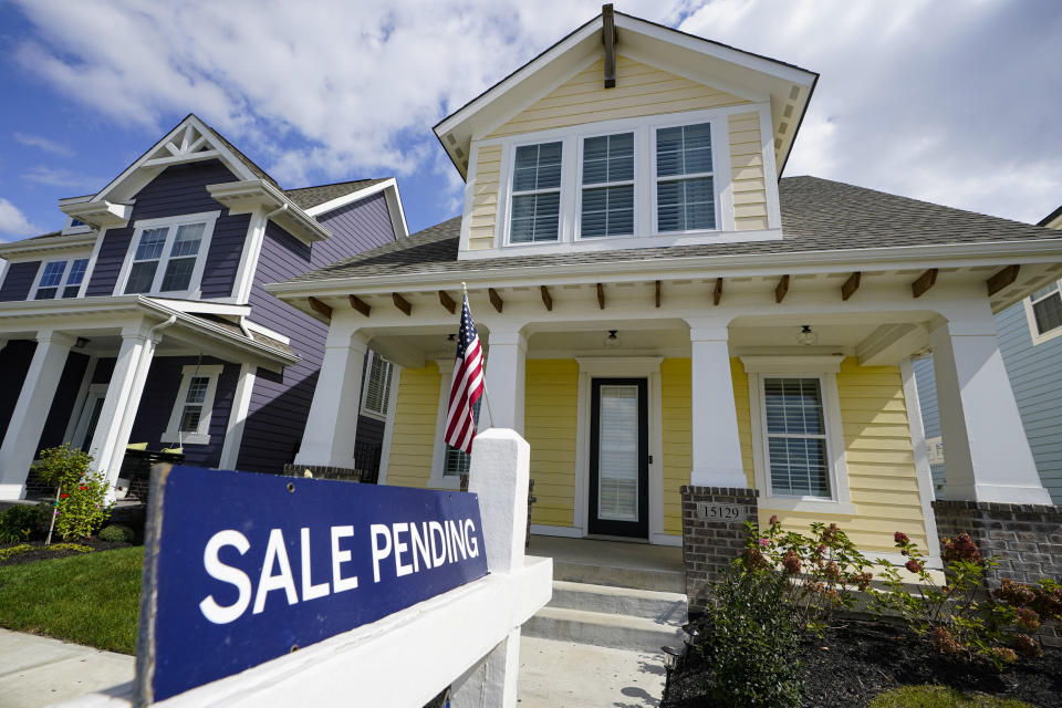 In this Friday, Sept. 25, 2020 photo, a "sale pending" sign is posted on.a home in Westfield, Ind.  The pending sales of existing homes fell 2.2% in September, the National Association of Realtors said Thursday, Oct. 29, the first monthly contraction of that figure in four months.  (AP Photo/Michael Conroy)