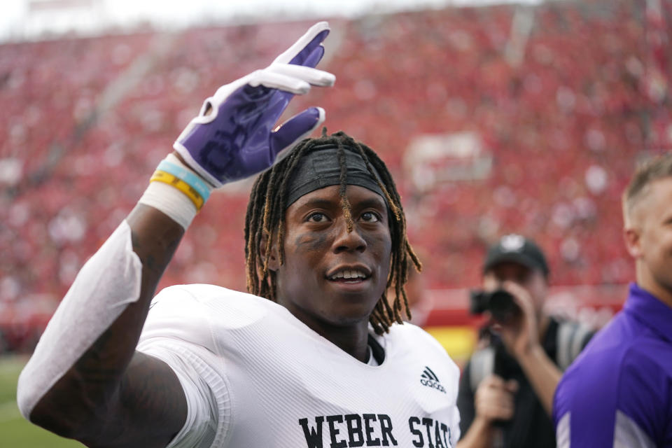 Weber State wide receiver Rashid Shaheed waves to the fans after scoring against Utah during the first half of NCAA college football game Thursday, Sept. 2, 2021, in Salt Lake City. (AP Photo/Rick Bowmer)