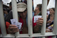 <p>A Honduran migrant shows the tickets given by Mexican immigration authorities that enables him and his family to cross the border between Guatemala and Mexico, in Ciudad Hidalgo, Mexico, Saturday, Oct. 20, 2018. Mexican officials are refusing to yield to demands from the caravan of Central American migrants that they be allowed to enter the country en masse, but announced they would hand out numbers to those waiting to cross and allow them to enter in small groups. (Photo: Oliver de Ros/AP) </p>