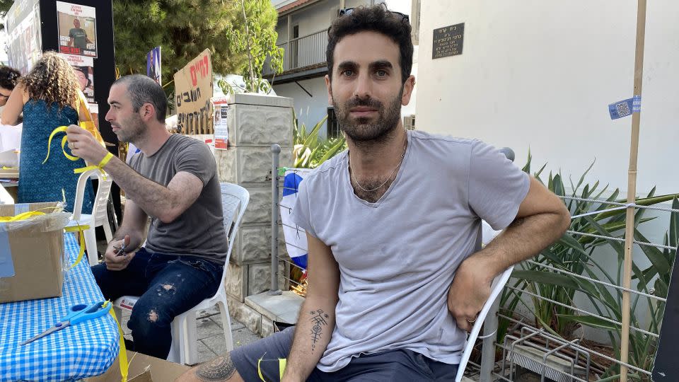 Yoav Peled, who was handing out yellow ribbons to people passing by a gathering spot for supporters of the hostages in Tel Aviv, is pictured on November 2. - Ivana Kottasova/CNN