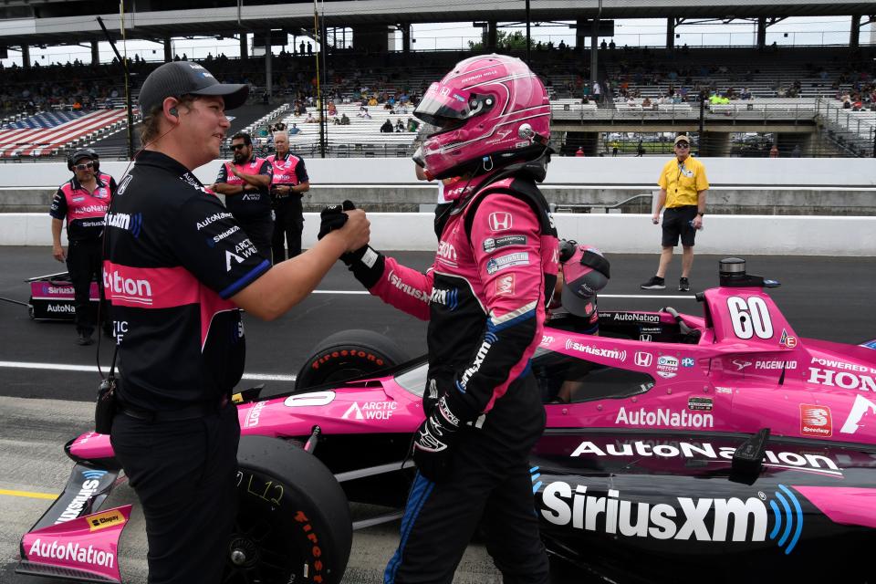 Meyer Shank Racing driver Simon Pagenaud (60) reacts with a crew member after his run Saturday, May 21, 2022, during the first day of qualifying for the 106th running of the Indianapolis 500 at Indianapolis Motor Speedway