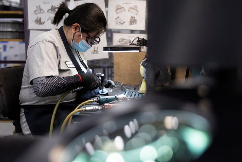 FILE PHOTO: A factory worker works on a machined aircraft part at Abipa Canada in Boisbriand