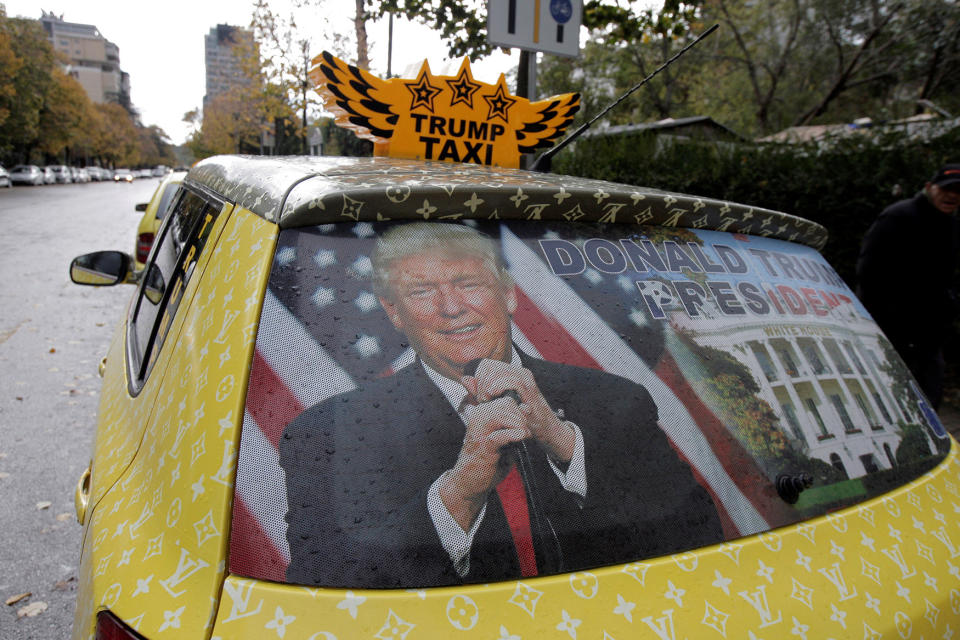 A car belonging to taxi driver Uljan Kolgjegja is decorated with a picture of Donald Trump