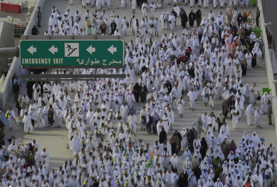 In this photo take by slow shutter, Muslim pilgrims walk to cast stones at a pillar in the symbolic stoning of the devil, during the last rite of the annual hajj, and the first day of Eid al-Adha, in Mina near the city of Mecca, Saudi Arabia, Saturday, July 9, 2022. (AP Photo/Amr Nabil)