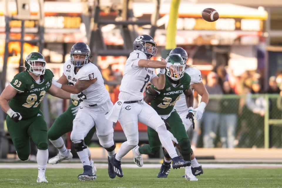 UC Davis Aggies quarterback Miles Hastings (7) passes under pressure during the third quarter at the Causeway Classic NCAA college football game Saturday, Nov. 19, 2022, at Hornet Stadium in Sacramento.