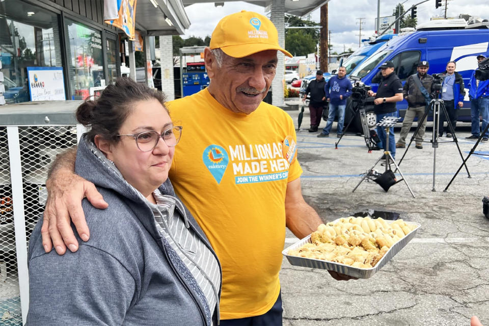 Joseph Chahayed, owner of the gas station, and his daughter Sandra Chahayed, hand out baklava. (Dua Anjum for NBC News)