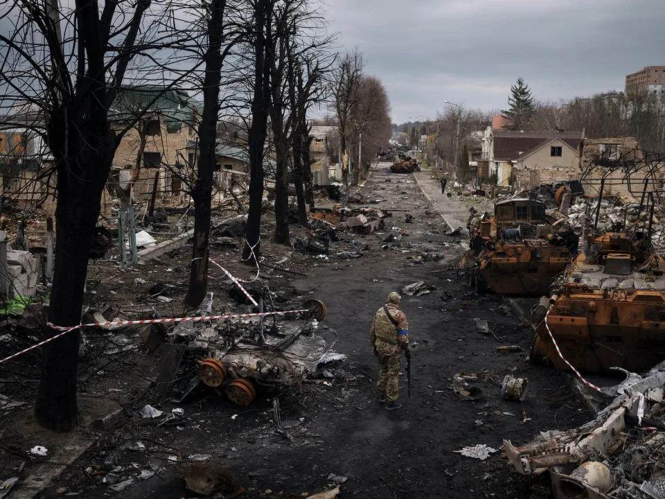 A Ukrainian serviceman walks amid destroyed Russian tanks in Bucha, on the outskirts of Kyiv, Ukraine, April 6, 2022.