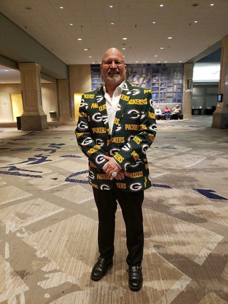 Dan "Bogie" Bogenschuetz poses in a Packers suit at a convention. People there found out he was a Packers fan, so he decided to dress the part, he said.