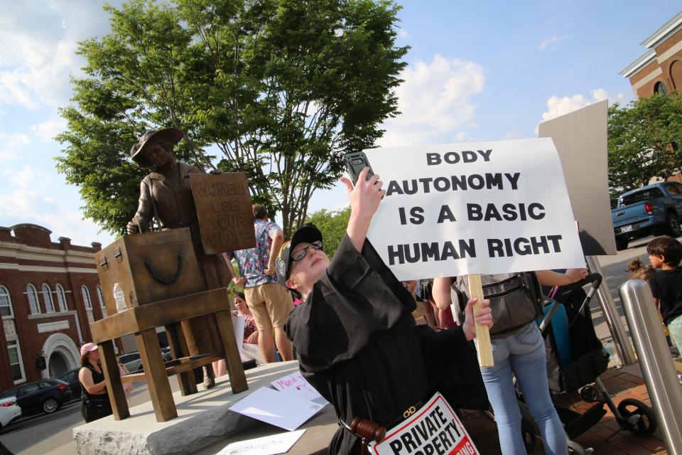 Mary King was dressed as RBG Friday and taking a selfie in front of the Tennessee Triumph statue before the march.