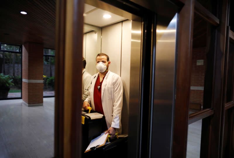Venezuelan doctor Leonardo Acosta enters an elevator before visiting a patient suffering from the coronavirus disease (COVID-19) for home treatment, in Caracas