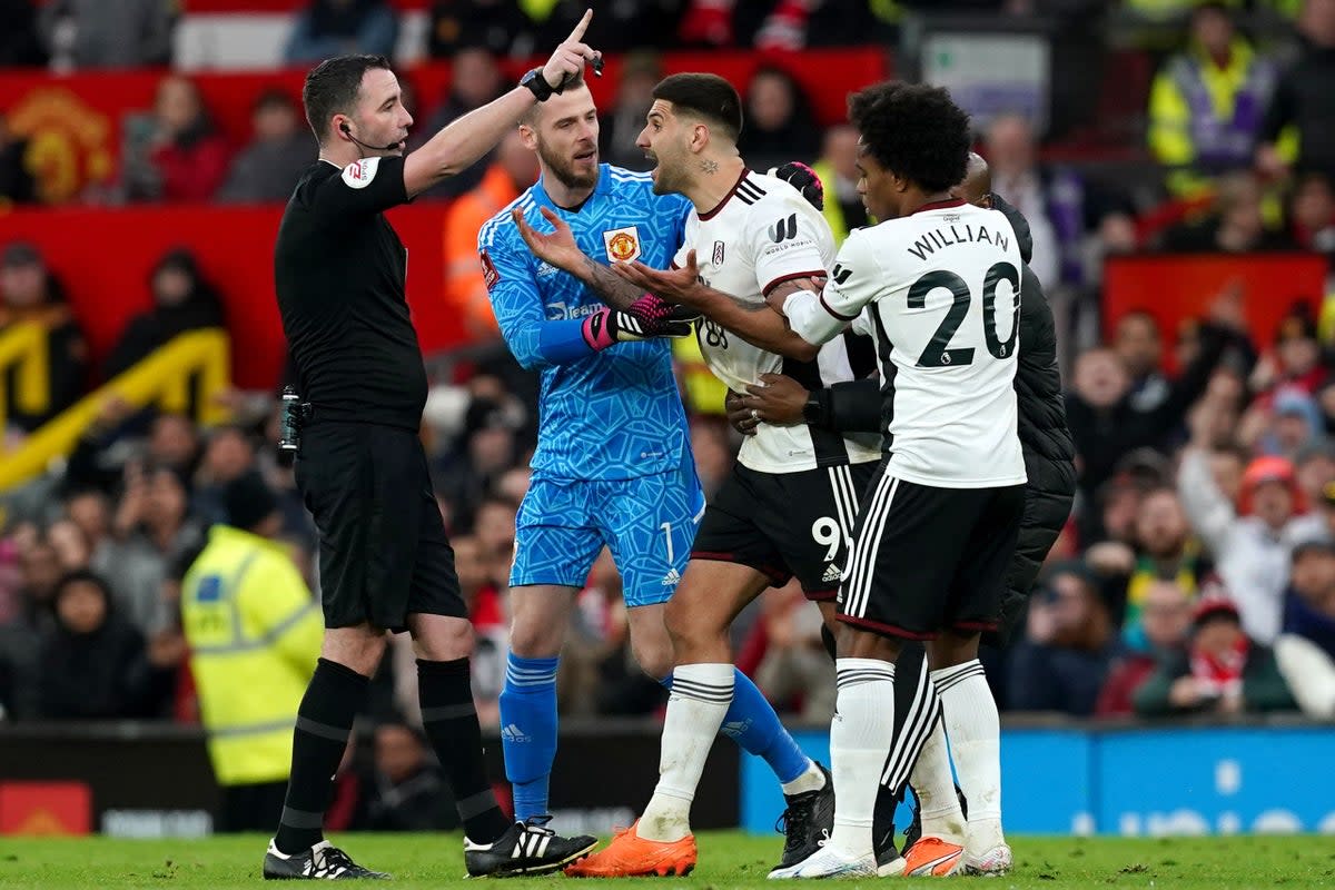 Aleksandar Mitrovic, centre, has been charged with violent conduct after grabbing referee Chris Kavanagh at Old Trafford (Martin Rickett/PA) (PA Wire)