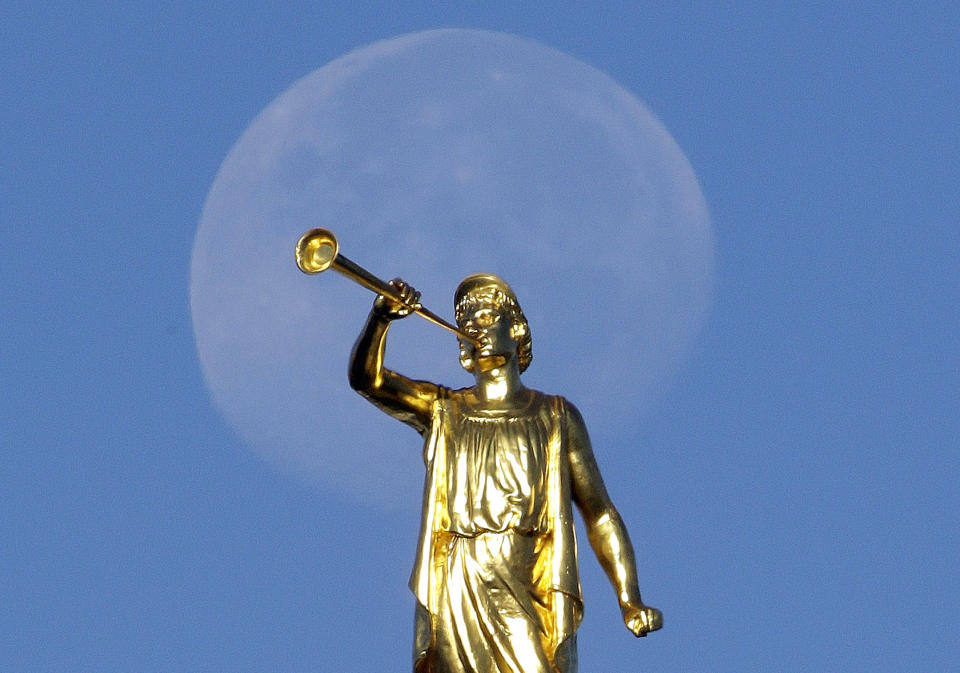 FILE - In this Sept. 11, 2014, file photo, the angel Moroni statue sits atop the Salt Lake Temple, at Temple Square, in Salt Lake City. The Mormon church won't stand in the way of a proposal to ban gay conversion therapy for minors in its home base of Utah, a position that advocates heralded as a milestone in the conservative state. (AP Photo/Rick Bowmer, File)