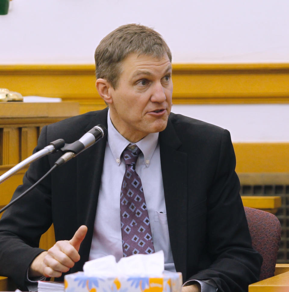 Medical examiner Dennis Klein testifies in court Thursday, Nov. 1, 2018, 2018 in Mount Pleasant, Iowa. Klein testified Thursday that a 4-month-old infant Sterling Koehn, found dead and maggot-infested in a baby swing last year, weighed only a few ounces more than his birth weight at the time of his death. The Courier reports that testimony came Thursday in the murder trial of the baby's father, 29-year-old Zachary Paul Koehn, who also faces a child endangerment count in the August 2017 death of his son, Sterling Koehn. (Jeff Reinitz/The Courier via AP)