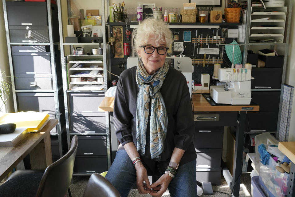 Mary Beth Orr poses for a photo in her home, Tuesday, Aug. 23, 2022 in Burien, Wash., south of Seattle. Orr used to have five or six drinks every evening and more on weekends before she enrolled in a study in 2018 to see if the compound in psychedelic mushrooms could help heavy drinkers cut back or quit entirely. She stopped drinking entirely for two years, and now has an occasional glass of wine, and credits psilocybin for her progress. (AP Photo/Ted S. Warren)