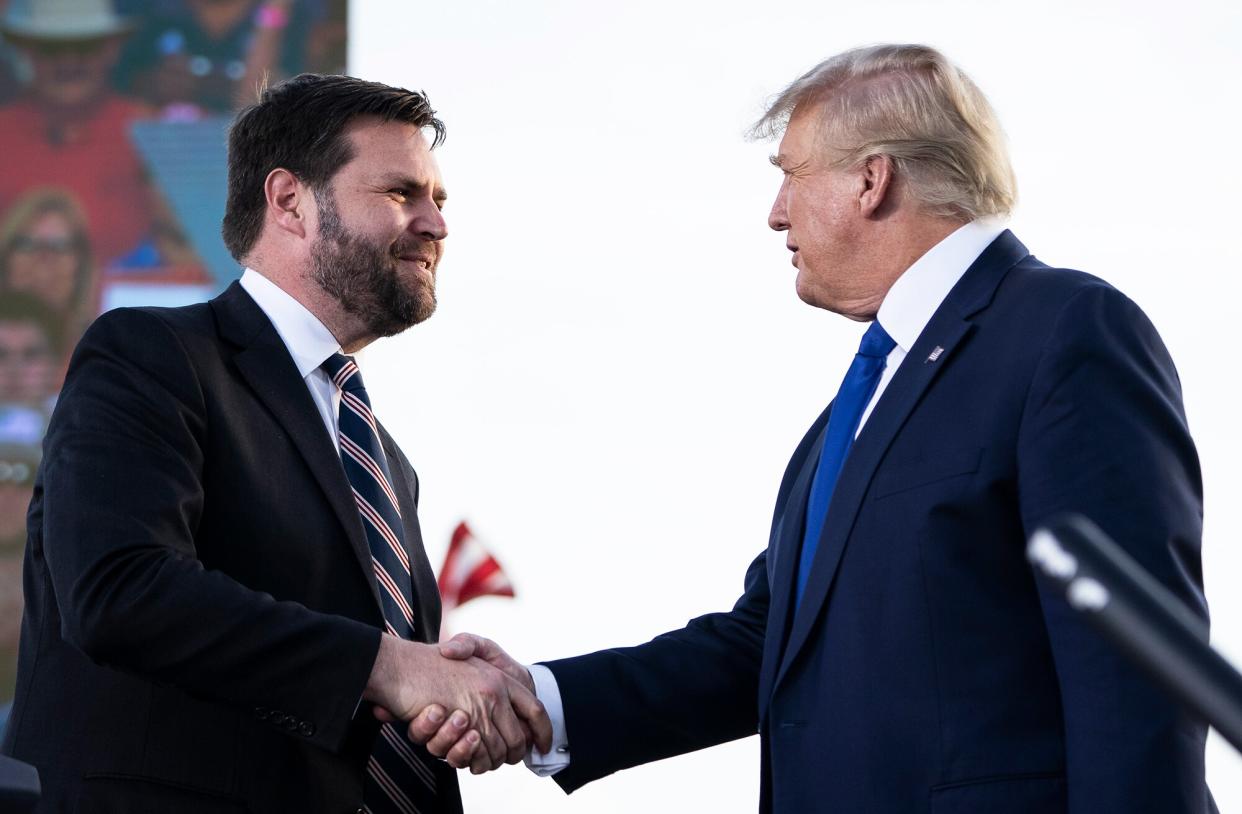 J.D. Vance, a Republican candidate for U.S. Senate in Ohio, shakes hands with former President Donald Trump during a rally hosted by the former president at the Delaware County