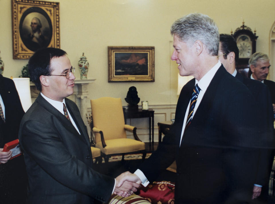 In this undated handout photo from 1997 provided by the Bundespresseamt, Governor of North Rhine-Westphalia and CDU top candidate for chancellor at the German general elections Armin Laschet, left, who was then a young politician, shakes hands with former US President Bill Clinton at the White House in Washington DC. (Bundespresseamt via AP)
