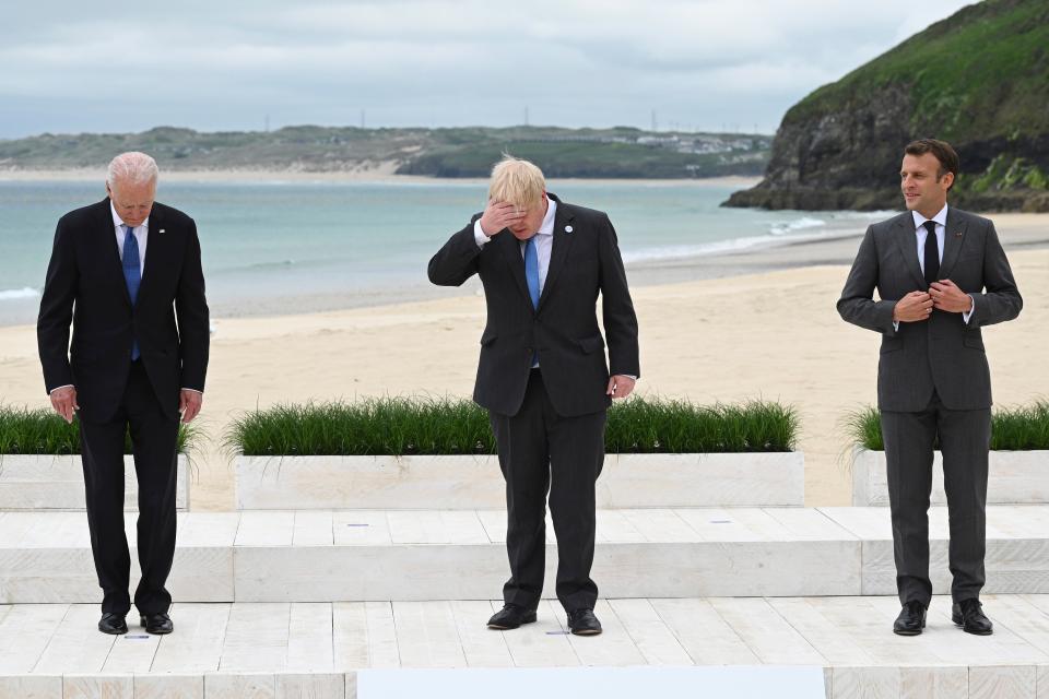 Headache: Boris Johnson lines up between presidents Joe Biden (left) and Emmanuel Macron as the G7 leaders gather for a group photo session in Carbis Bay, Cornwall, on Friday (AP)