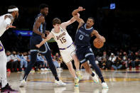 Memphis Grizzlies guard De'Anthony Melton (0) drives against Los Angeles Lakers guard Austin Reaves (15) during the first half of an NBA basketball game in Los Angeles, Sunday, Oct. 24, 2021. (AP Photo/Ringo H.W. Chiu)