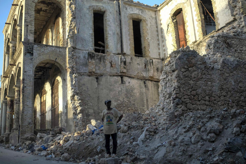 A man stands close to the rubble of a collapsed building in Jeremie, Haiti, Wednesday, Aug. 18, 2021, four days after the city was struck by a 7.2-magnitude earthquake. (AP Photo/Matias Delacroix)