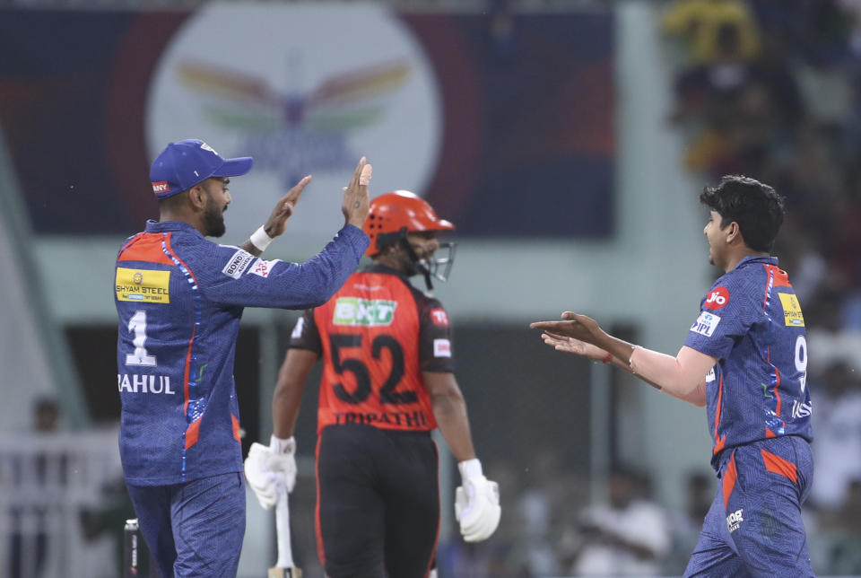 Yash Thakur, right, of Lucknow Super Giants celebrates after taking the wicket of Rahul Tripathi of Sunrisers Hyderabad with captain KL Rahul, during the Indian Premier League cricket match in Lucknow, India, Friday, April 7, 2023. (AP Photo/Surjeet Yadav)